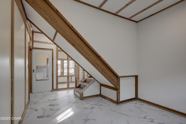 additional living space featuring marble finish floor, baseboards, and stairs