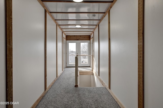 hallway featuring carpet floors and french doors