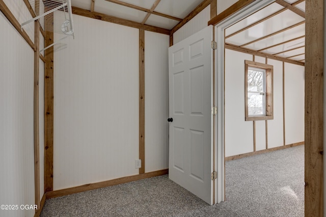 interior space featuring baseboards and carpet flooring