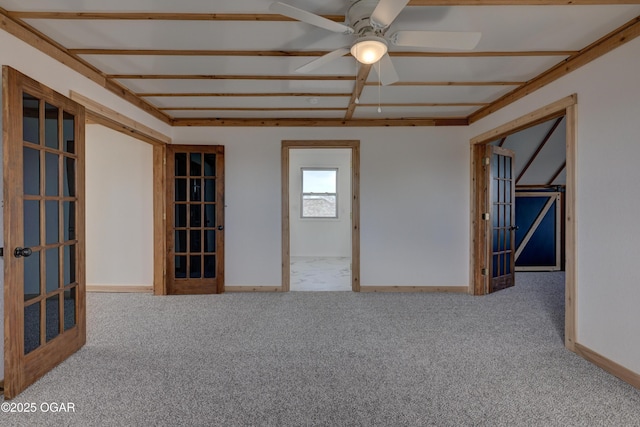 empty room featuring carpet floors, a ceiling fan, and baseboards