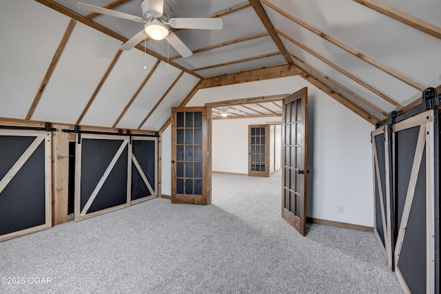 bonus room featuring vaulted ceiling, ceiling fan, a barn door, and carpet flooring