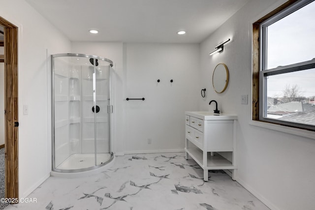 bathroom with marble finish floor, a shower stall, baseboards, and vanity