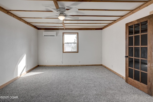 carpeted spare room with ceiling fan, a wall mounted air conditioner, and baseboards