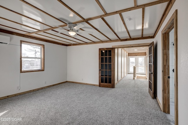 unfurnished room featuring baseboards, ceiling fan, a wall mounted air conditioner, carpet, and french doors