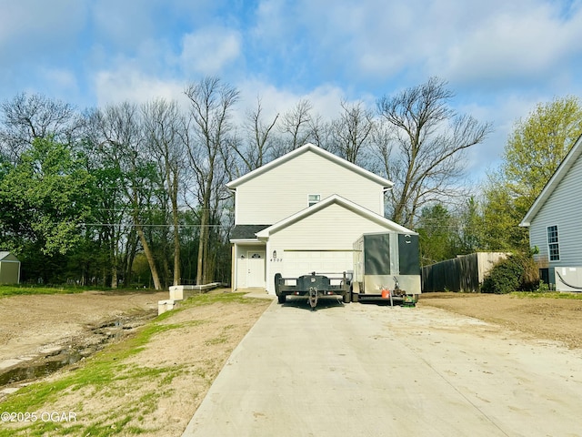 view of side of property featuring fence and driveway