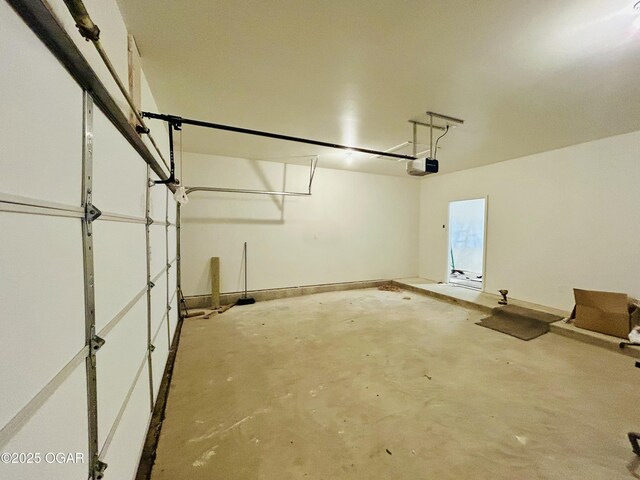 garage with baseboards and a garage door opener