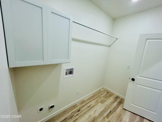 clothes washing area with cabinet space, light wood-style flooring, electric dryer hookup, washer hookup, and baseboards