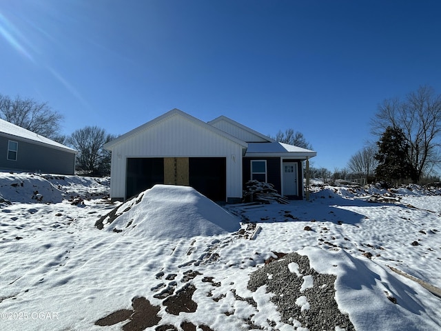 view of front of property with an attached garage and an outdoor structure