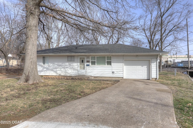 single story home featuring a garage, a front lawn, and concrete driveway