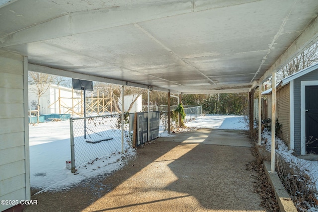 view of patio featuring a carport and fence