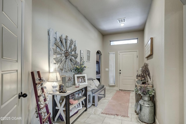 entryway featuring arched walkways and visible vents