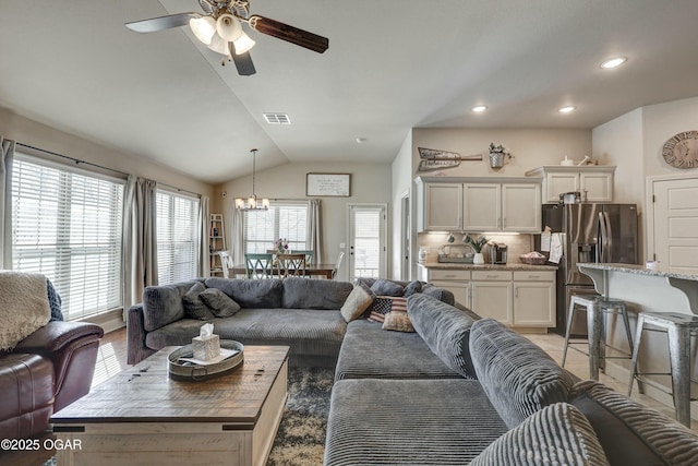 living area with recessed lighting, visible vents, vaulted ceiling, and ceiling fan with notable chandelier