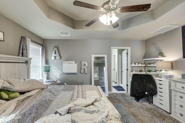 bedroom featuring a raised ceiling, visible vents, ceiling fan, and carpet flooring