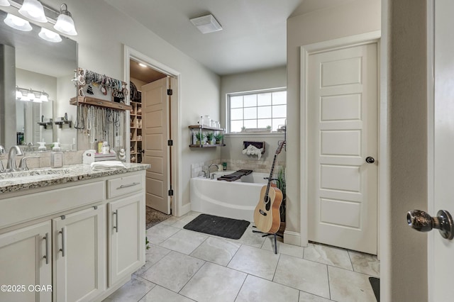 full bathroom with tile patterned flooring, vanity, and a bath