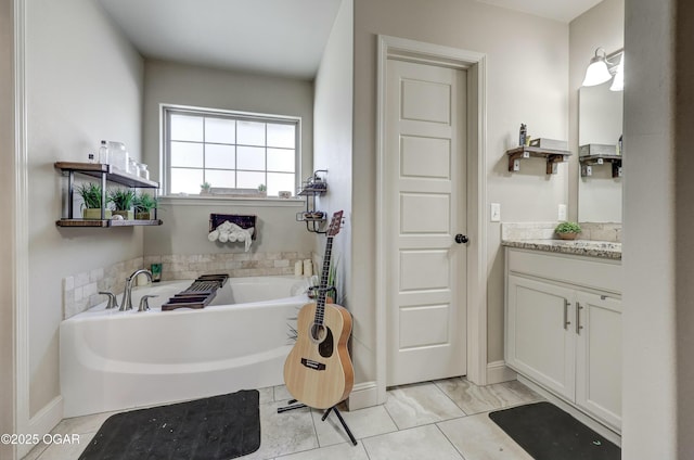 bathroom with a garden tub and vanity