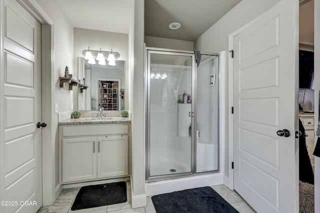 full bathroom with a shower stall and vanity