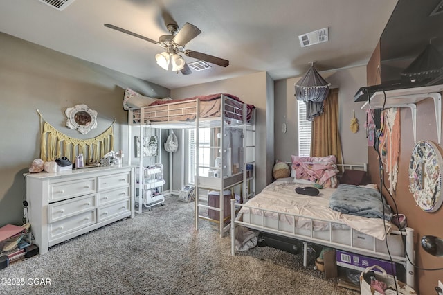 carpeted bedroom with visible vents and a ceiling fan