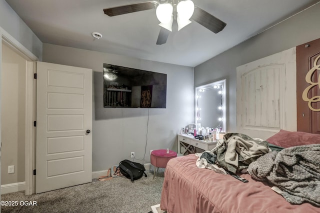 bedroom with a ceiling fan, carpet flooring, and baseboards