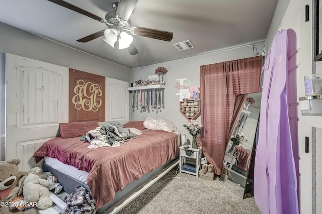 bedroom featuring ceiling fan, visible vents, and light colored carpet