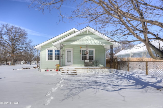 view of front of house featuring covered porch and fence