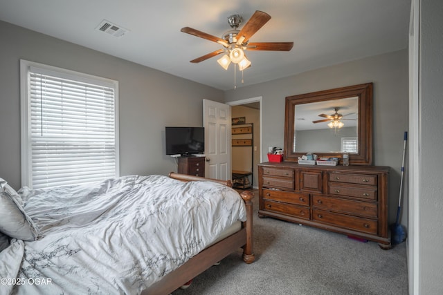 bedroom with carpet flooring, visible vents, and ceiling fan