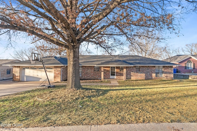 single story home with driveway, a garage, a front lawn, and brick siding