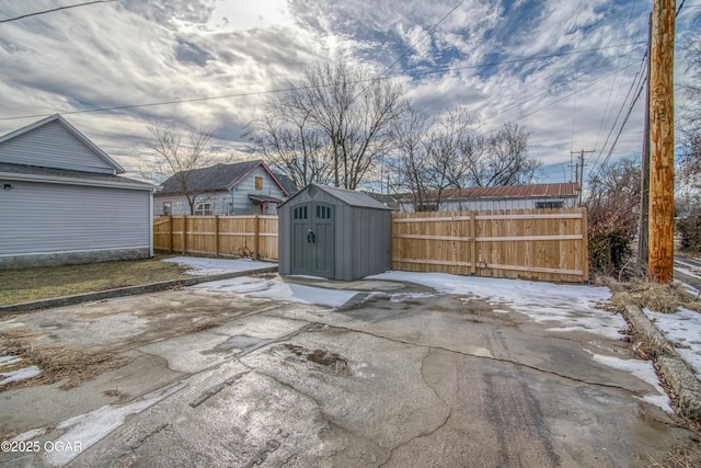 view of patio featuring an outbuilding, a shed, and a fenced backyard