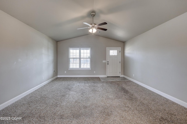 interior space featuring lofted ceiling, carpet, a ceiling fan, and baseboards