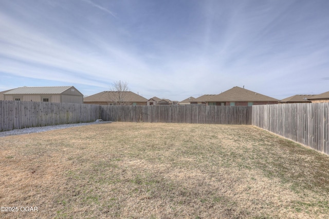 view of yard with a fenced backyard