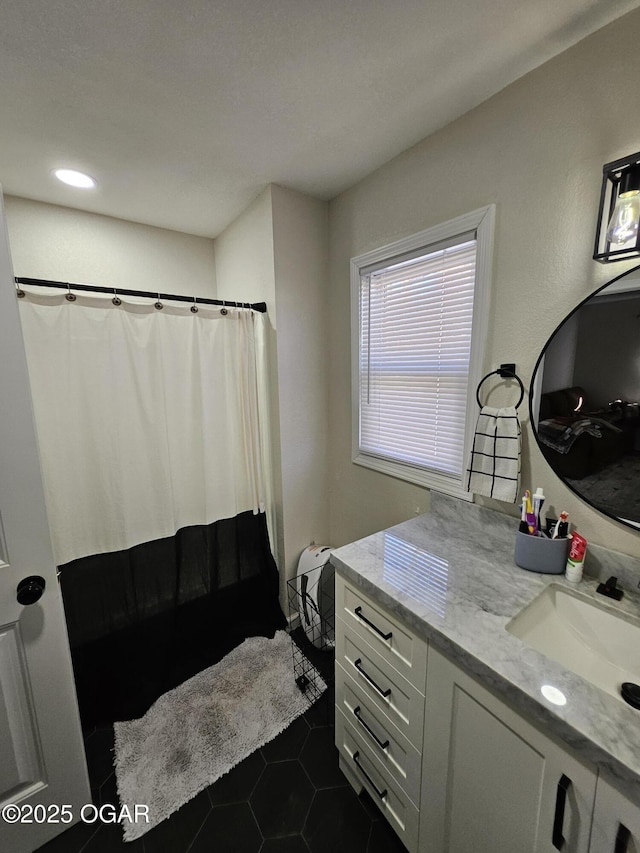 full bath featuring a shower with curtain, vanity, and tile patterned floors