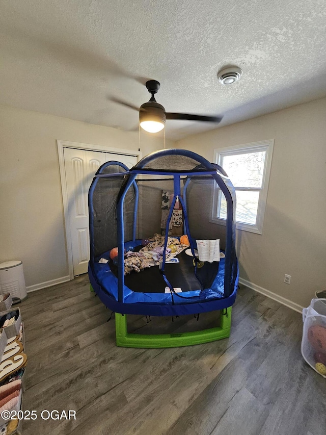 bedroom featuring baseboards, visible vents, and dark wood finished floors