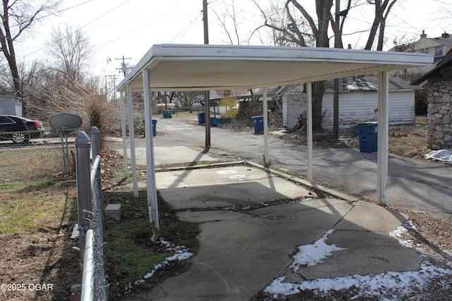 view of car parking featuring a detached carport and fence