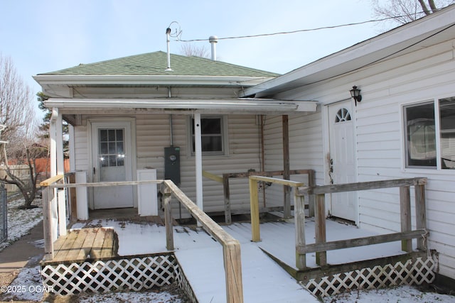 exterior space featuring a shingled roof