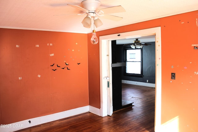 unfurnished room featuring a ceiling fan, crown molding, baseboards, and wood finished floors