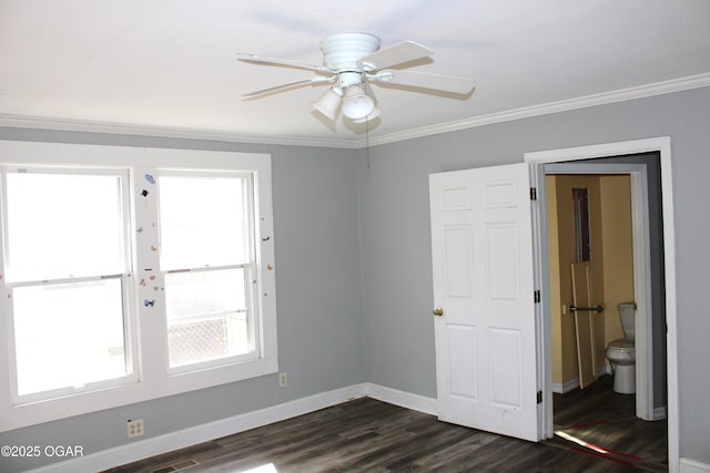 unfurnished room with a ceiling fan, baseboards, ornamental molding, and dark wood-type flooring