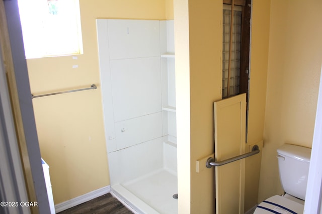 full bathroom with a stall shower and toilet