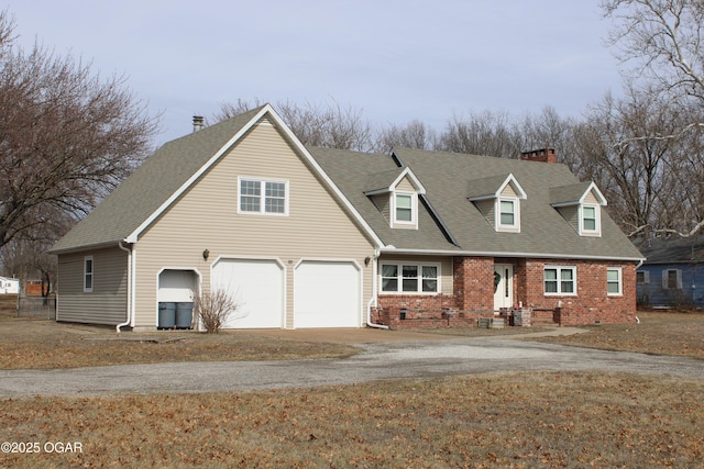 view of front facade with a shingled roof, brick siding, driveway, and an attached garage