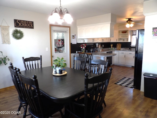 dining room featuring dark wood-style floors, ceiling fan with notable chandelier, and a wealth of natural light