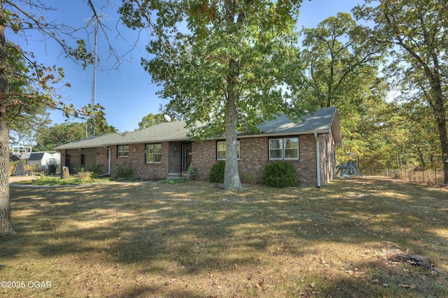 ranch-style home featuring a front yard and brick siding