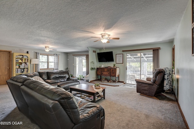 living room featuring a textured ceiling, a ceiling fan, and carpet flooring