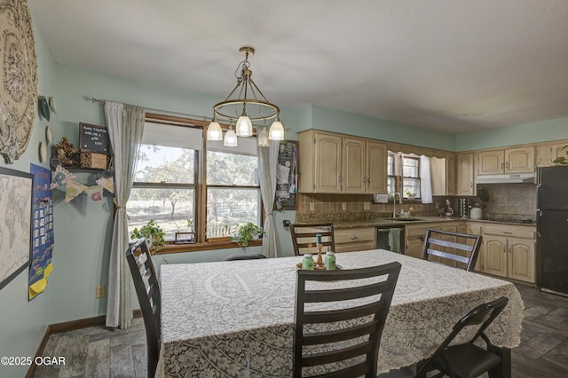 kitchen featuring tasteful backsplash, freestanding refrigerator, light brown cabinets, and a sink