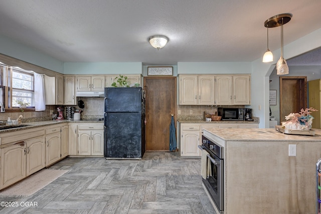 kitchen featuring decorative backsplash, under cabinet range hood, black appliances, pendant lighting, and a sink