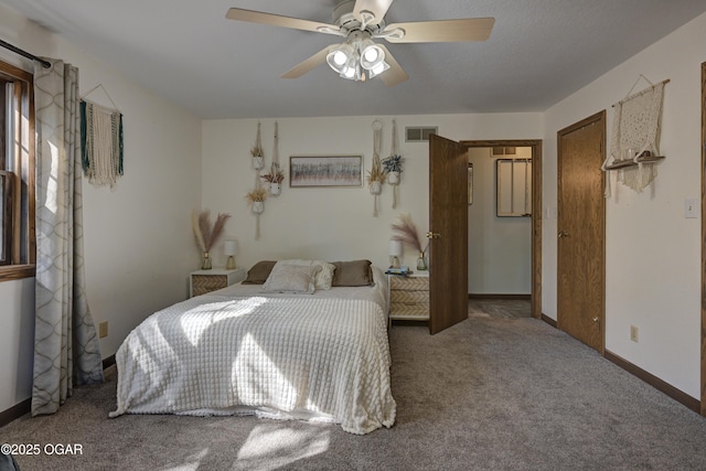 carpeted bedroom featuring visible vents, ceiling fan, and baseboards