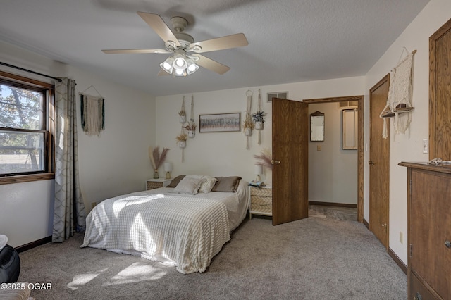 bedroom with ceiling fan, carpet floors, visible vents, and baseboards