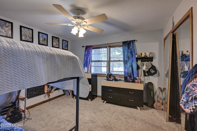 bedroom featuring baseboards, light colored carpet, ceiling fan, a textured ceiling, and a closet