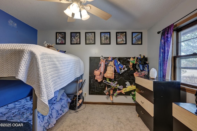 bedroom featuring a ceiling fan, carpet, a textured ceiling, and baseboards