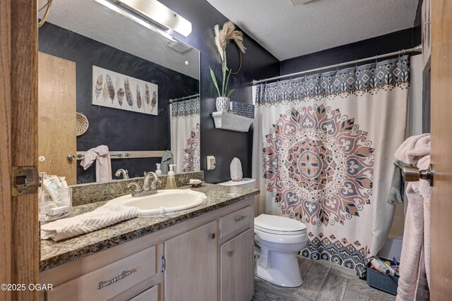 bathroom featuring a shower with shower curtain, a textured ceiling, toilet, and vanity