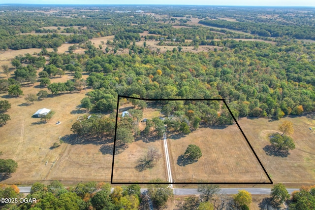 birds eye view of property with a wooded view