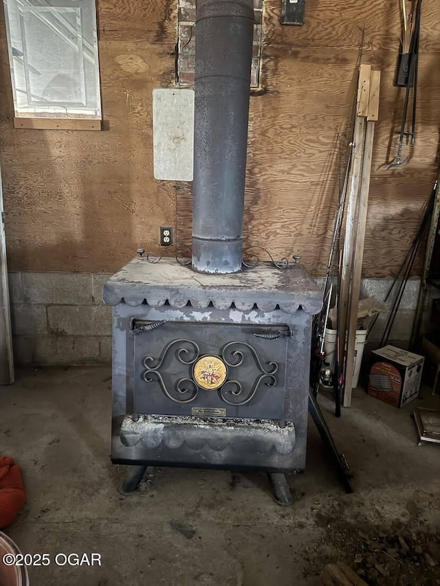 interior details featuring a wood stove and concrete floors