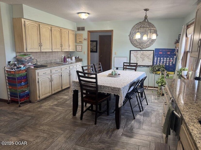 dining space with a chandelier, a textured ceiling, and visible vents